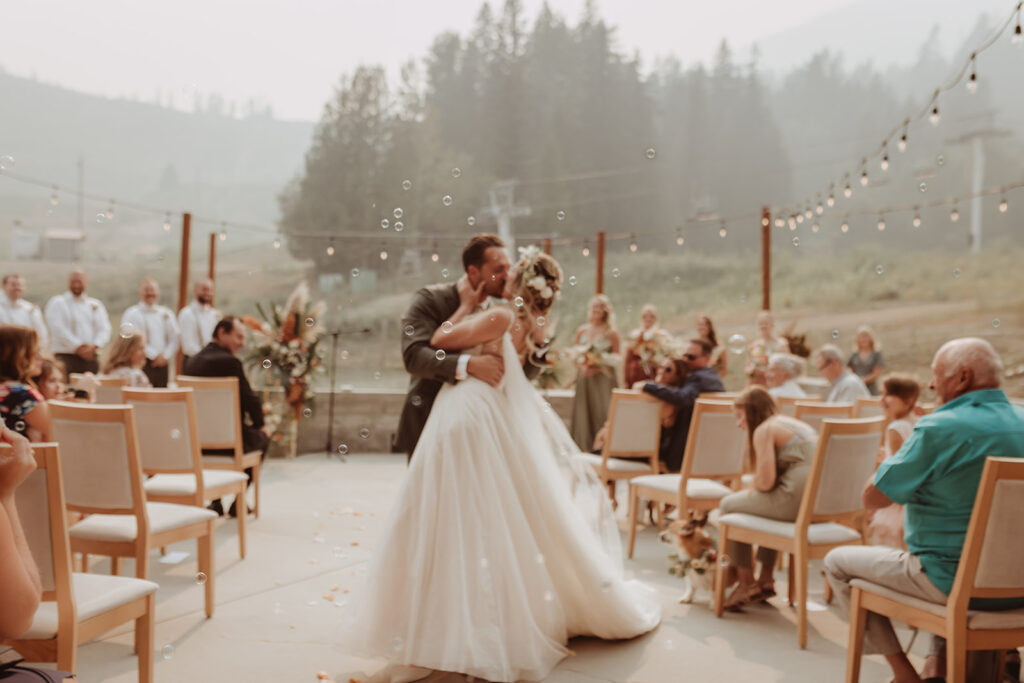 Wildfire Smoke and first kisses from the newlyweds during a wedding ceremony at Rossland's slope-side resort The Josie Hotel
