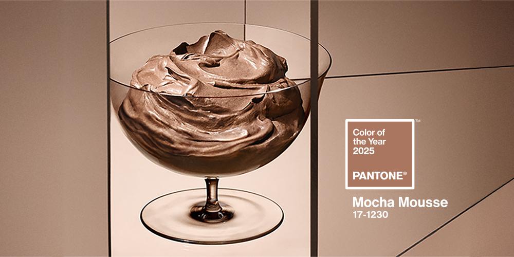 Pantone Color of the Year 2025, Mocha Mousse (17-1230), showcased in a rich, creamy dessert-like display within a glass bowl, highlighting its warm and earthy brown tones.